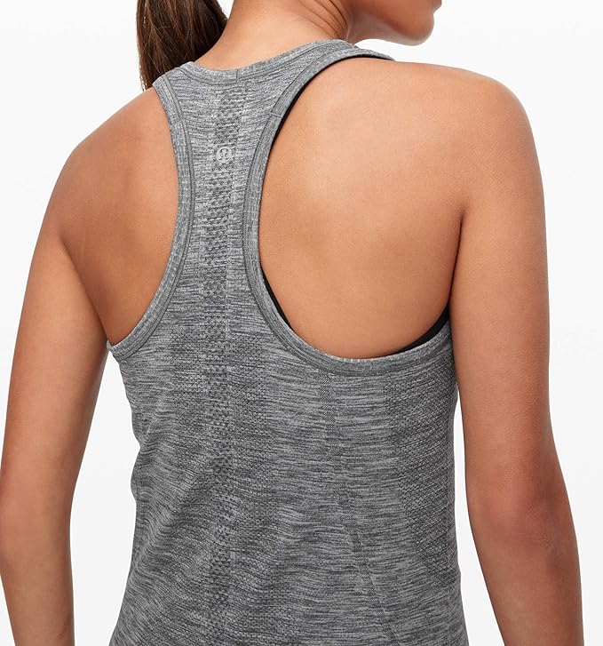 The Swiftly Tech Racerback Tank Top is a popular and versatile athletic tank top that is favored by fitness enthusiasts. Made from high-quality materials, this tank top offers a comfortable and snug fit, allowing for easy movement during workouts.

Crafted with sweat-wicking fabric, the Swiftly Tech Racerback Tank Top effectively keeps you dry and cool even during intense exercise sessions. Its moisture-wicking properties help to quickly evaporate sweat, preventing discomfort and promoting optimal performance.

The tank top's racerback design ensures unrestricted shoulder movement, making it perfect for activities that involve a wide range of arm motions. This design feature also adds a trendy touch to the tank top's overall look.

One of the key features of the Swiftly Tech Racerback Tank Top is its seamless construction. This technique eliminates any rough seams or irritating stitching, enhancing the overall comfort and reducing the risk of chafing. This sleek and minimalist design is both functional and aesthetically pleasing.

In addition to its performance benefits, the Swiftly Tech Racerback Tank Top also offers style and versatility. Its simple yet fashion-forward design makes it suitable for various occasions and can be easily paired with other workout or casual attire.

Available in a range of colors and sizes, the Swiftly Tech Racerback Tank Top caters to different preferences and body types. Whether you prefer a vibrant hue or a classic neutral tone, there is a style for everyone.

Overall, the Swiftly Tech Racerback Tank Top is an excellent choice for individuals looking for a reliable and stylish athletic tank top. Its blend of comfort, functionality, and versatility make it a staple in many fitness wardrobes. Description by ChatGPT.