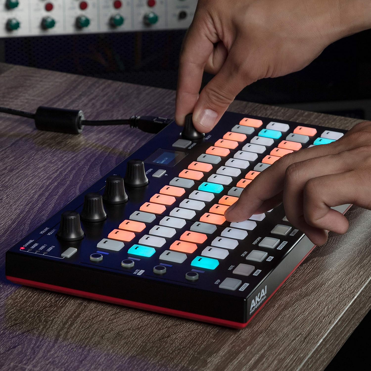 Hand adjusting a knob on the Akai Fire controller