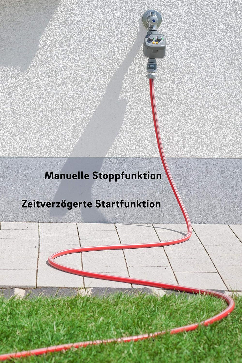 REHAU irrigation timer connected to a hose, illustrating the manual stop and time delay functions.