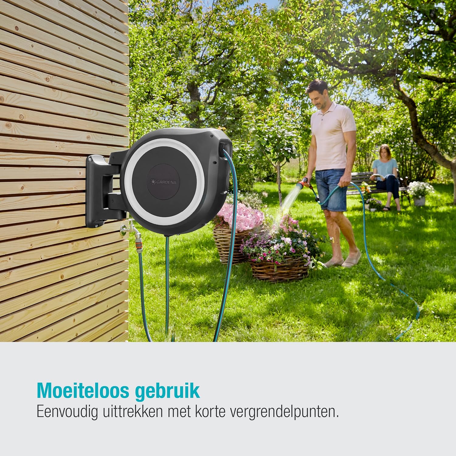 Person extending Gardena hose from wall box