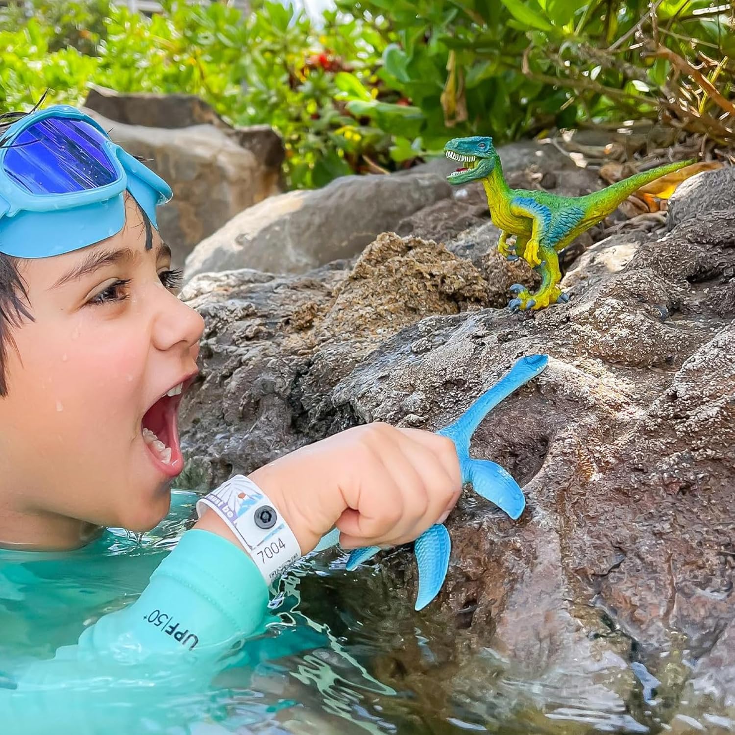 Child playing with Schleich Velociraptor and other dinosaur toys