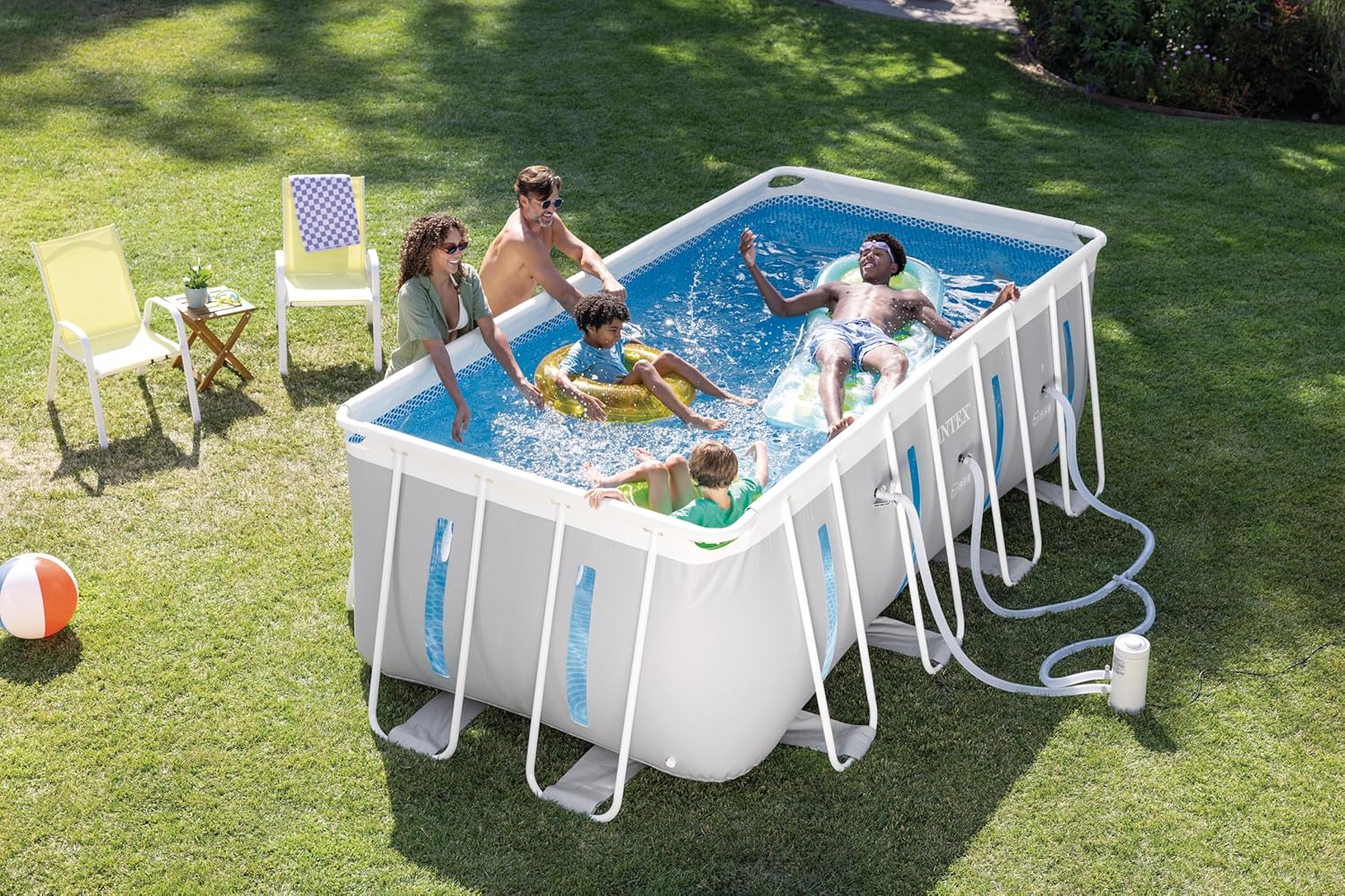 Family assembling the Intex Prism Frame Clearview Rectangular Pool in their backyard.