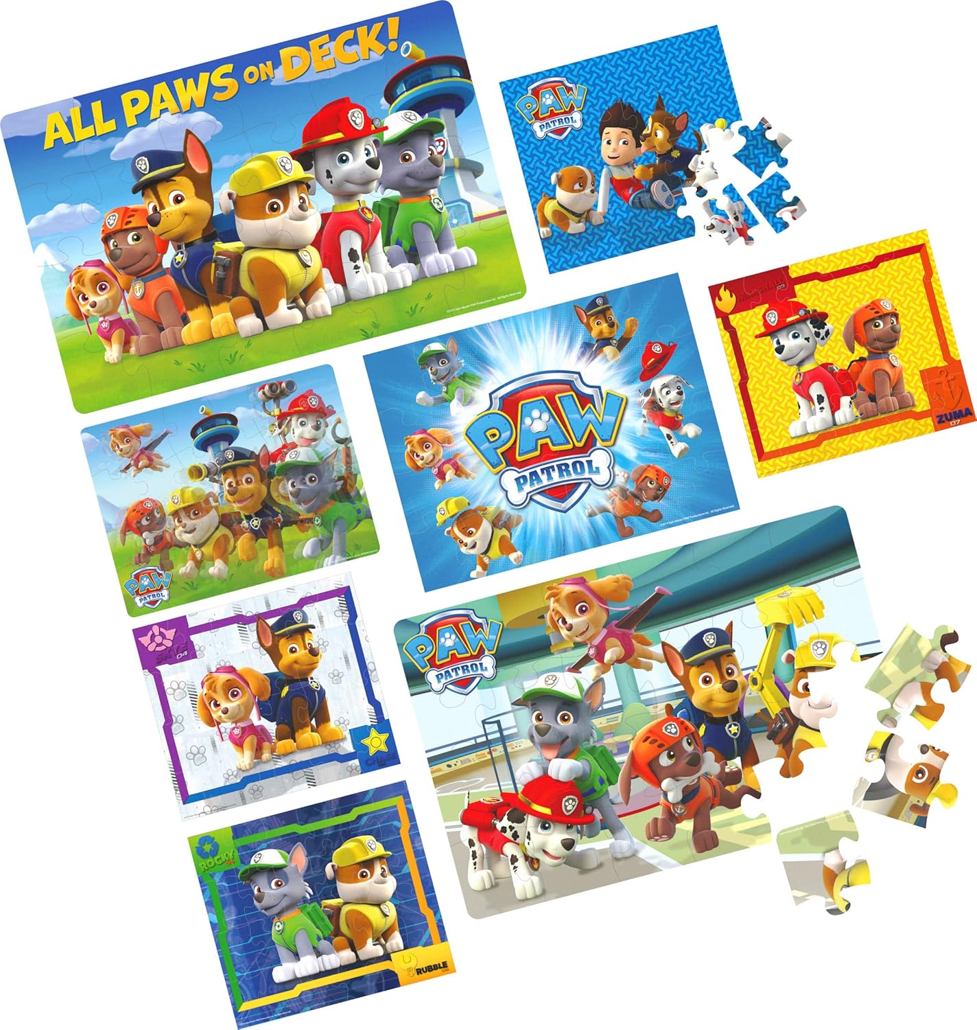 Eight different Paw Patrol puzzles laid out, some fully assembled and some with loose pieces, showcasing the variety of designs in the pack.