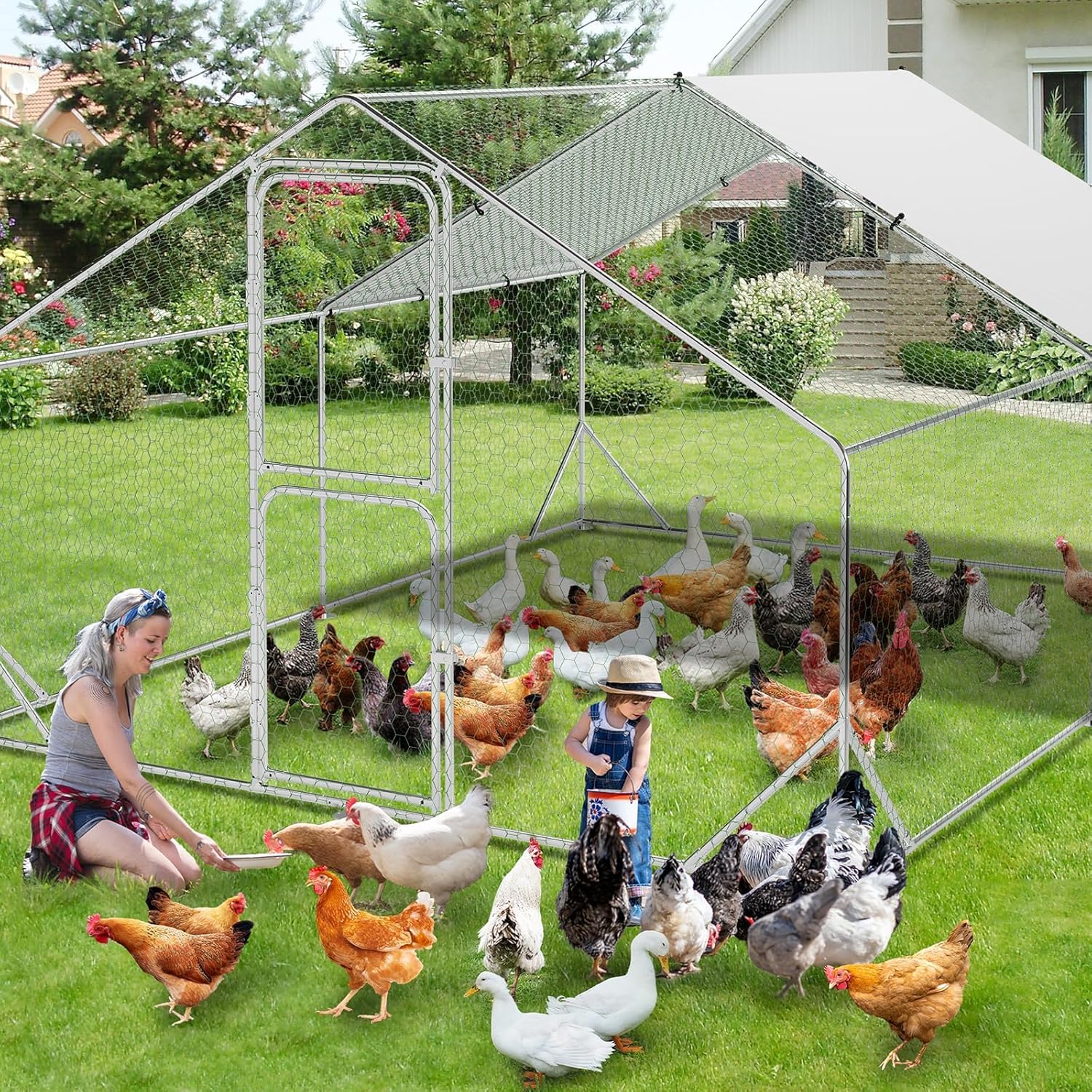 Woman and child inside the Garvee walk-in chicken coop with poultry.