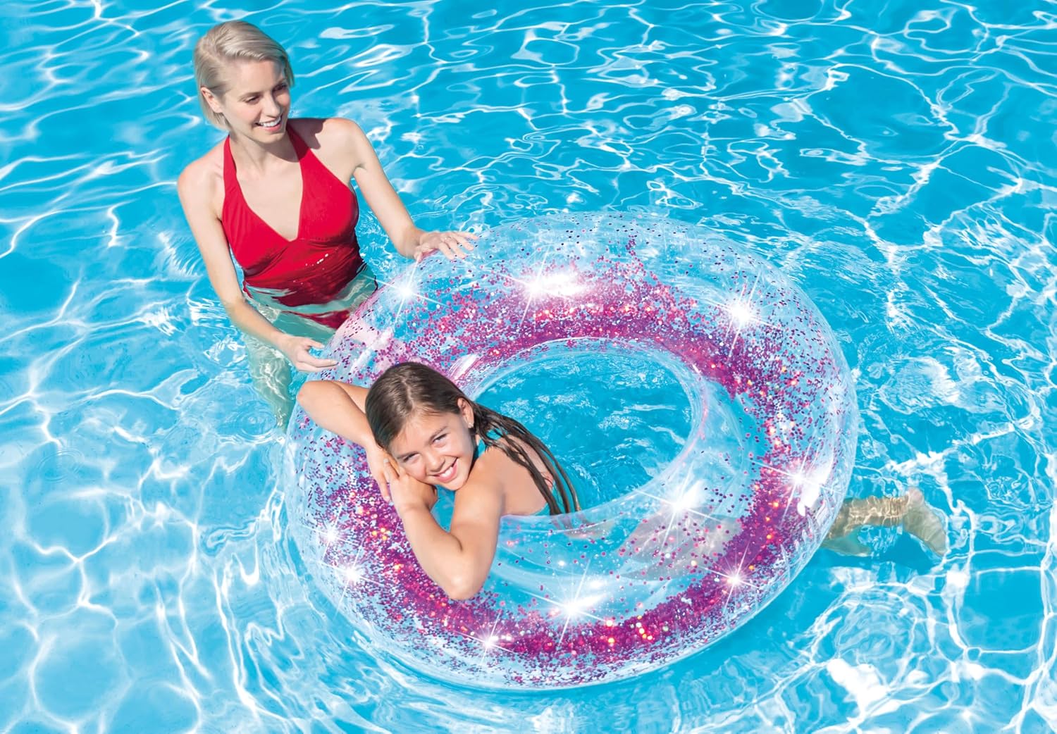 A child and an adult enjoying the gold Intex Glitter Inflatable Ring in a swimming pool.