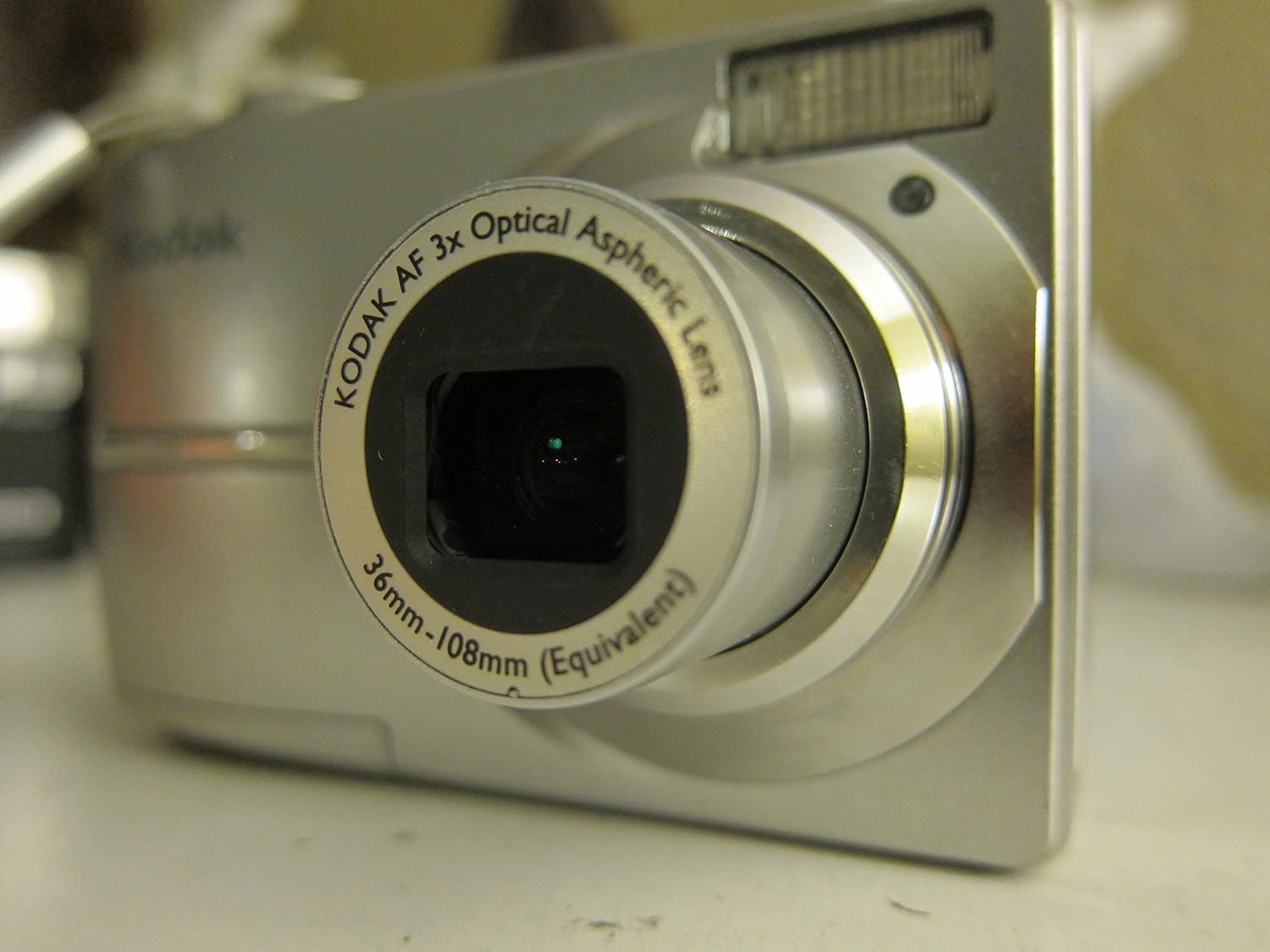 Angled front view of Kodak Easyshare C713 camera with lens extended