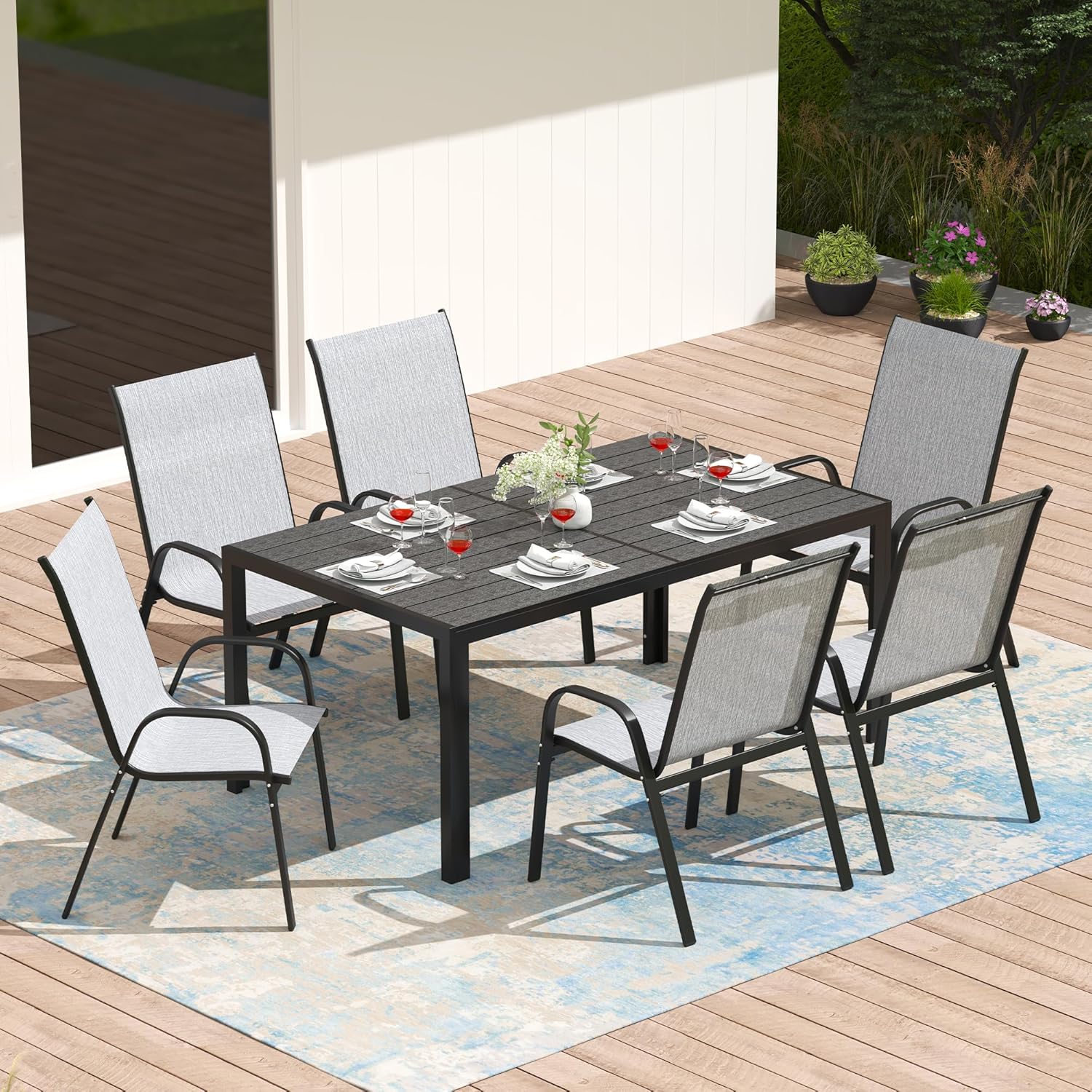 Samlet set view of the assembled 7-piece outdoor dining set on a patio.