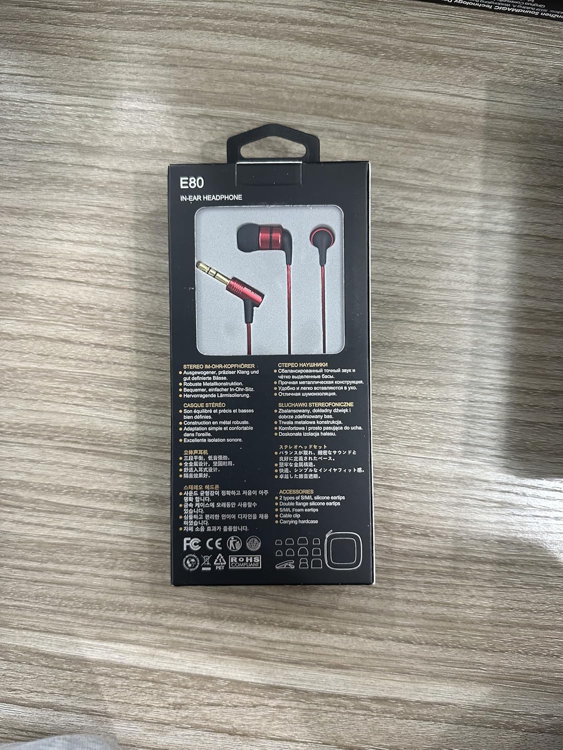 Back view of the SoundMAGIC E80 earbud product box with multi-language features and accessories list