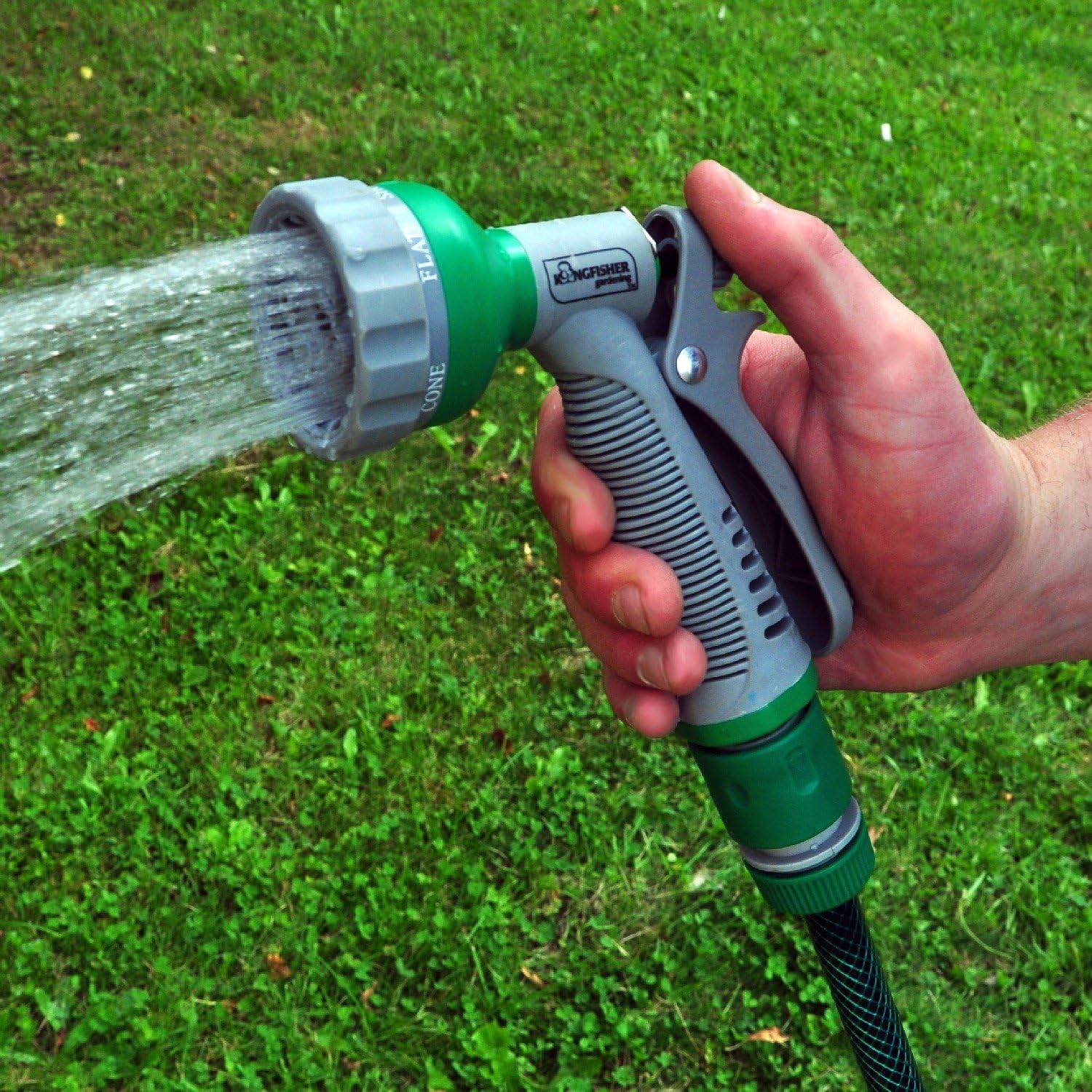 Hand holding Kingfisher 6 Dial Spray Gun in use, showing water spraying