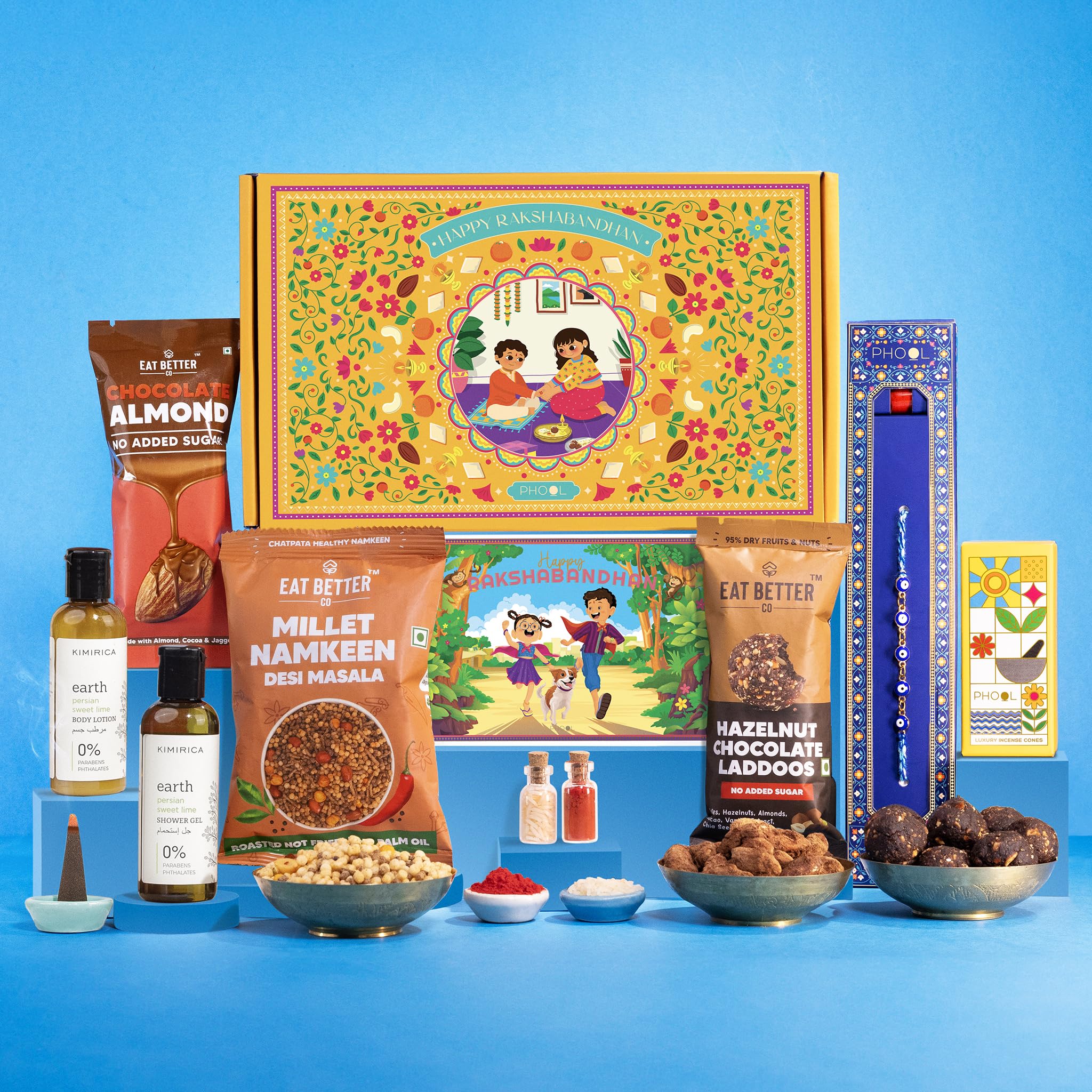 Phool Rakhi Gift for Brother - 7 Inclusions + Evil Eye Rakhi - Nazar Kavach Evil Eye | Eat Better Choco Almonds, Healthy Millet Namkeen, Hazelnut Laddos, Kimirica Shower Gel & Body Lotion, Personalized Greeting Card - Rakhi Combo Gift Box for Bhaiya & Bhabhi