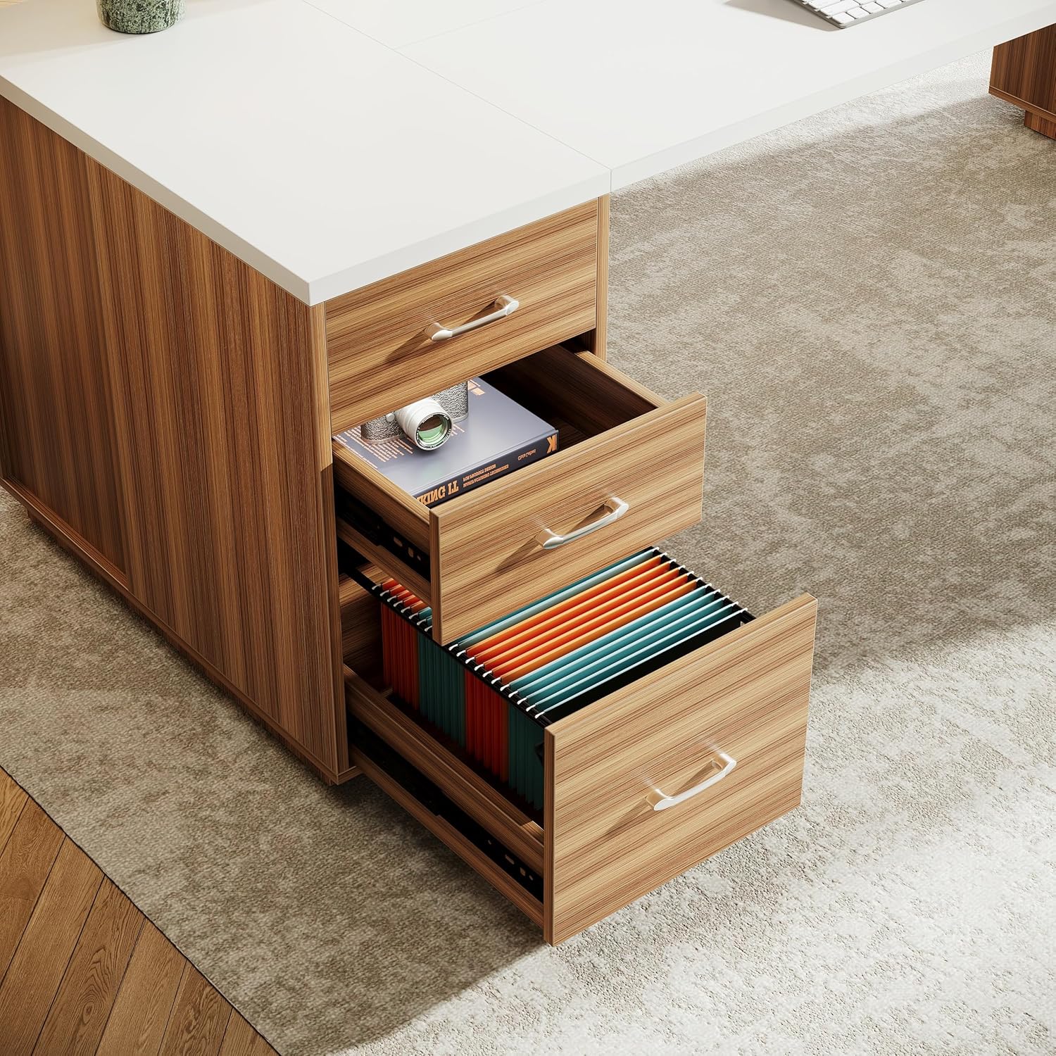 Close-up of the desk's drawers, showing a file drọwa nwere nkwudo files and a regular storage drawer.