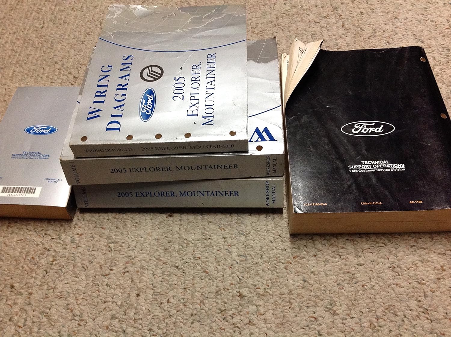 Side view of the repair manual set, showing the Ford logo and 'Technical Support Operations' on one of the binders.