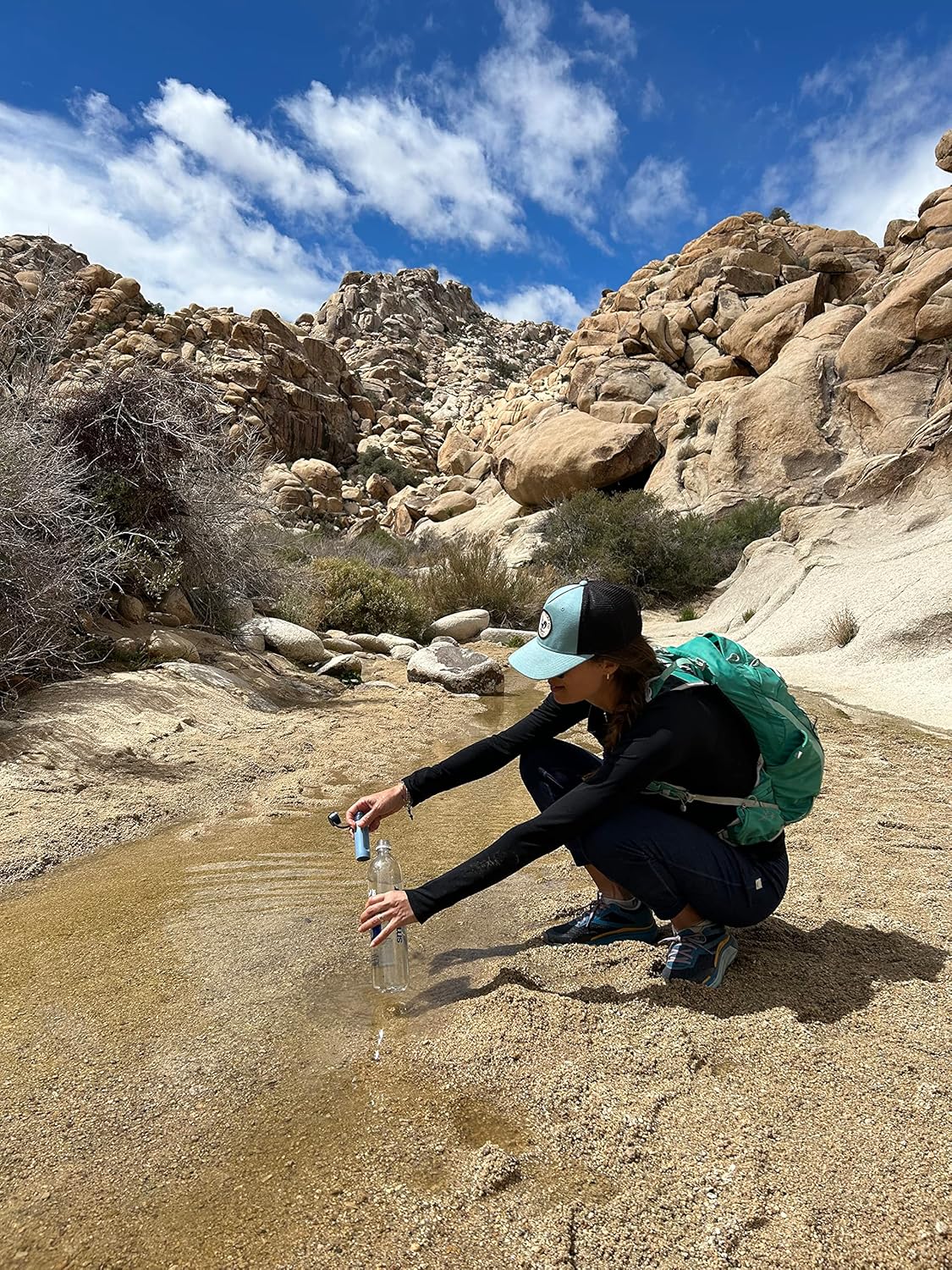 Woman collecting water with LifeStraw Peak Series Solo filter