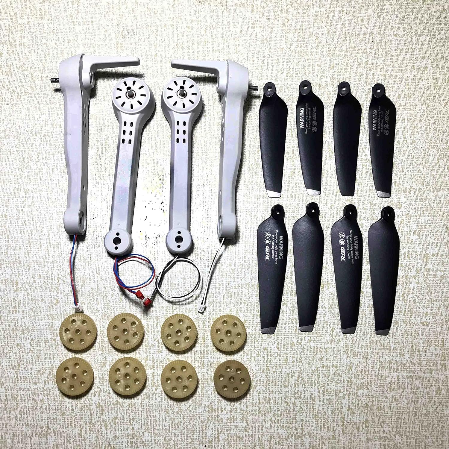 Image of various drone accessories including propellers, gears, and motor arms.