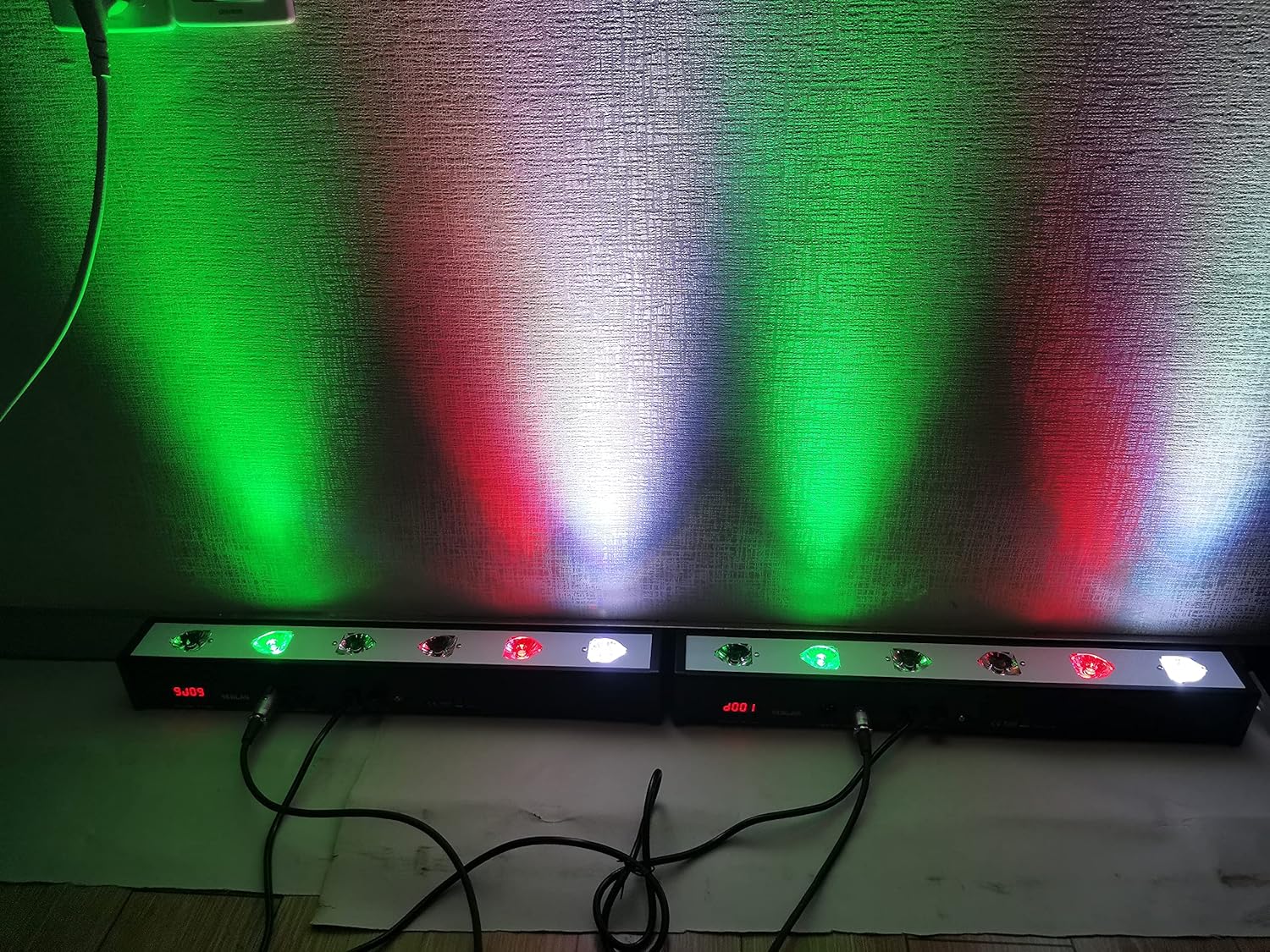 Two SENLAN LED Par Bars illuminating a wall with green, red, and white light