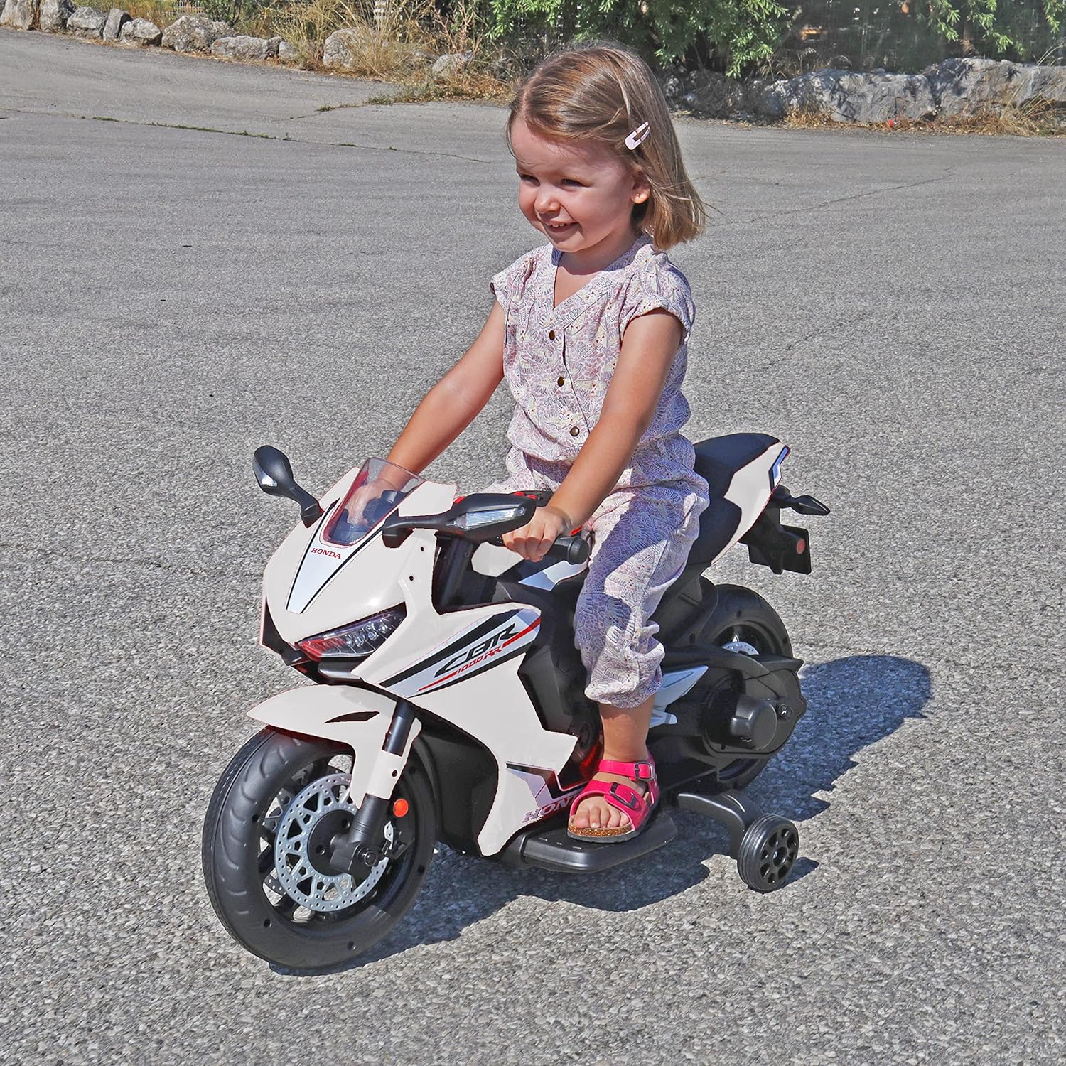 Child riding TURBO CHALLENGE Honda CBR1000RR Electric Ride-On Motorcycle outdoors