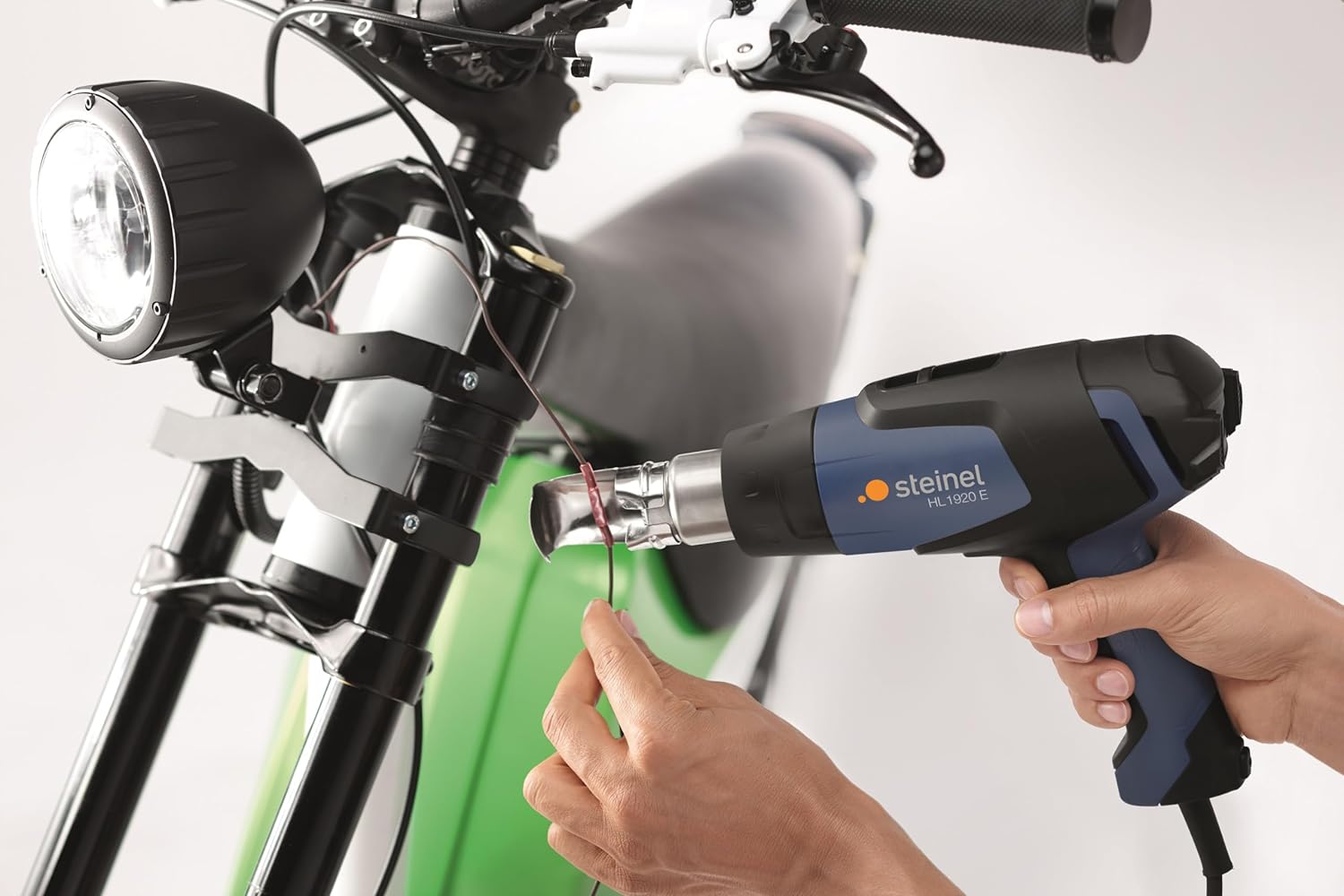 Steinel HL 1920 E Heat Gun being used for car wrapping, applying heat to vinyl film