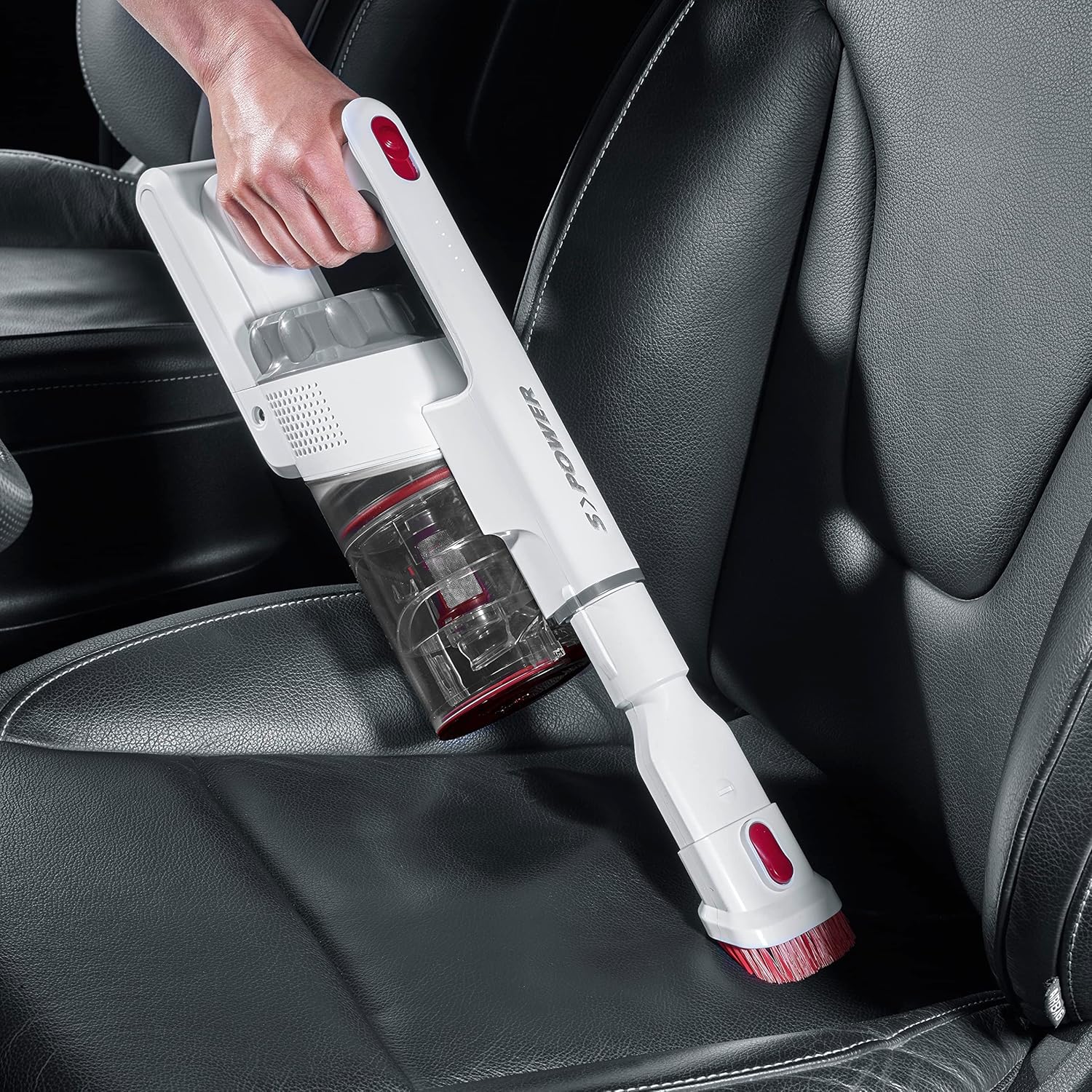 Person using the Severin HV 7152 as a handheld vacuum with the upholstery brush to clean a car seat.