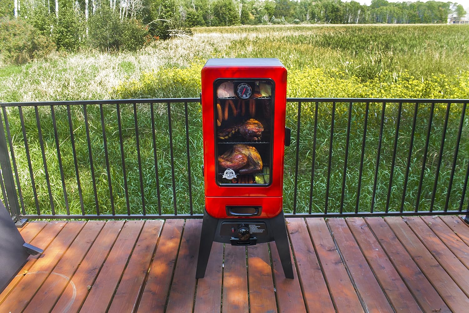 Pit Boss 2 Series Gas Vertical Smoker in an outdoor setting with food cooking inside
