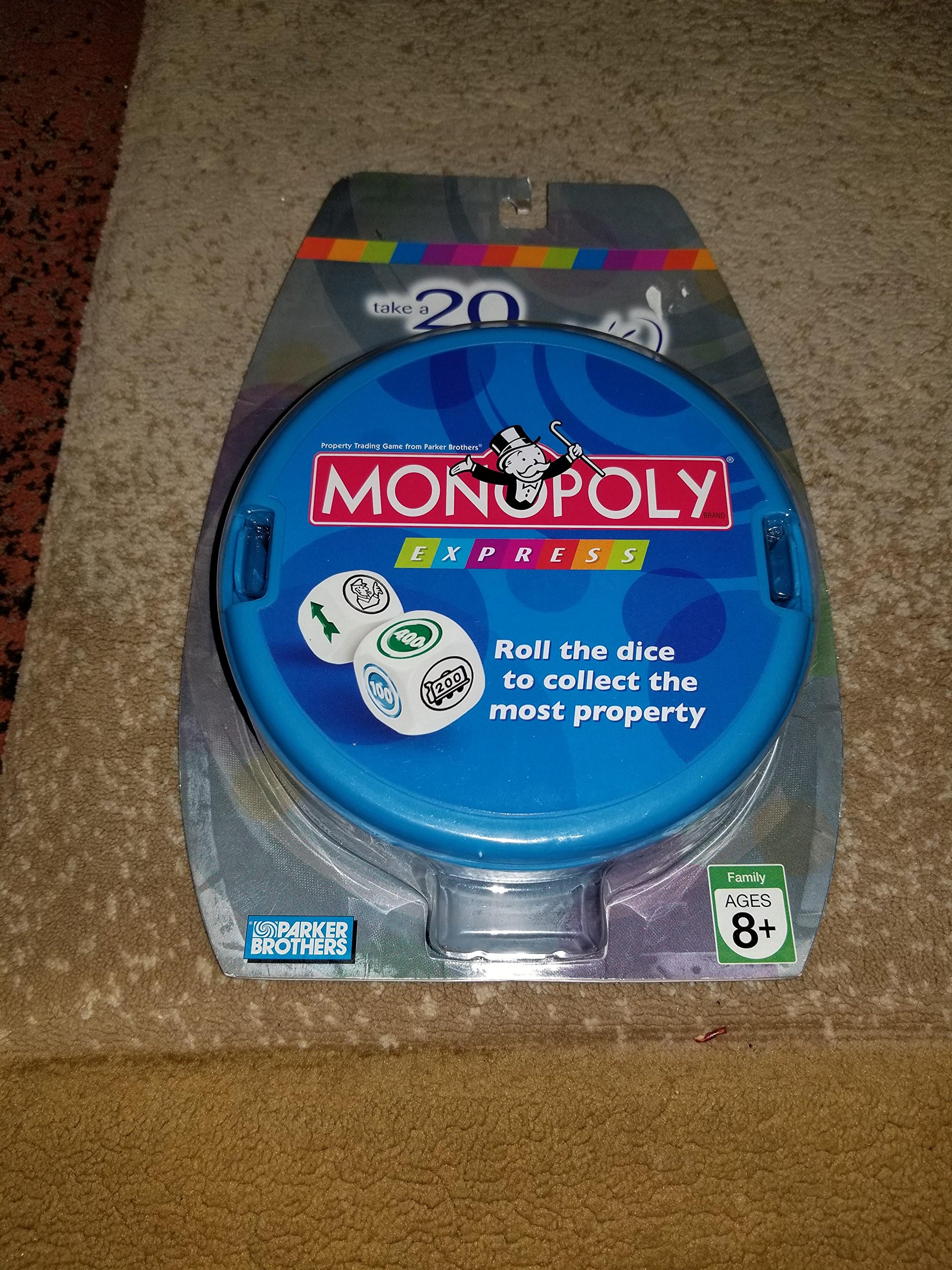 Monopoly Express game in its blue circular case, with dice visible on the lid.