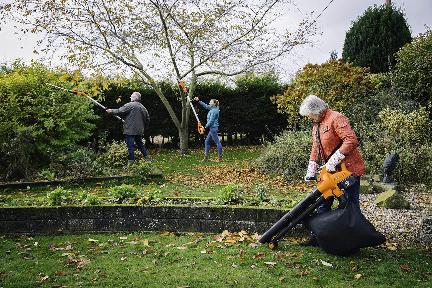 People using various Yard Force 20V power tools in a garden