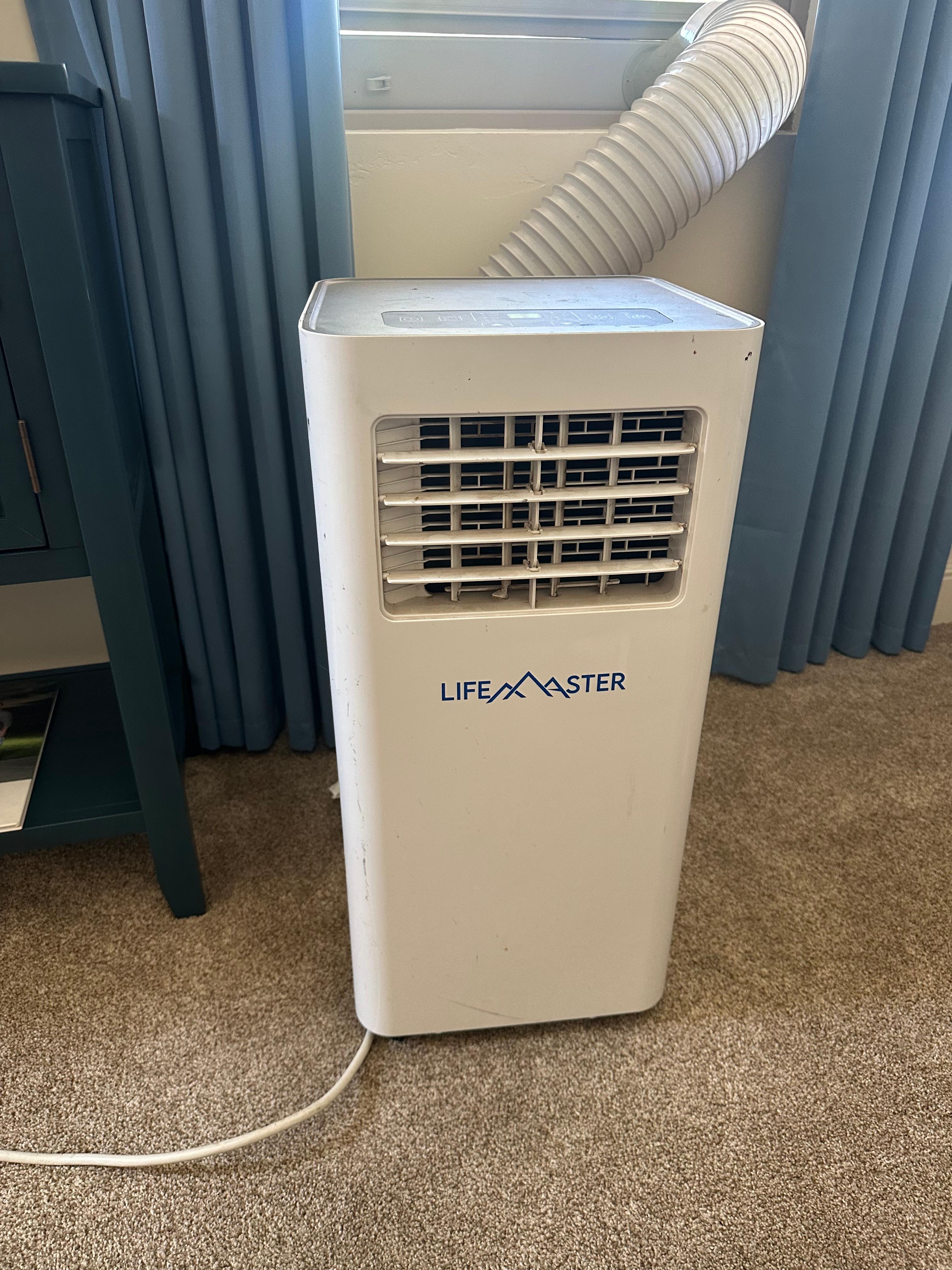 Top control panel of the portable air conditioner showing digital display and buttons for mode, fan speed, timer, and power.