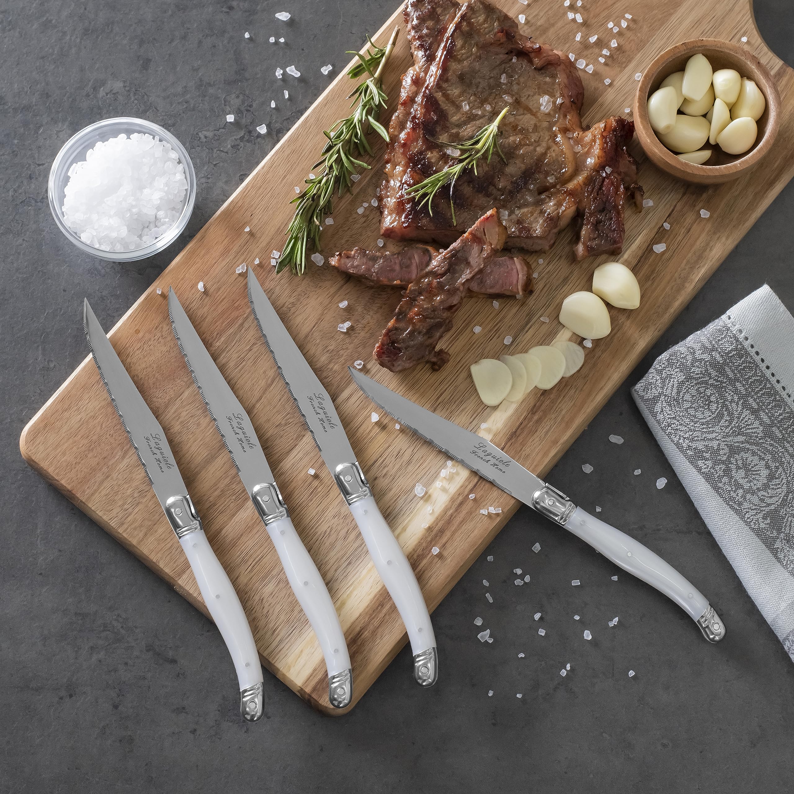 Condition photo showing New/Like New for French Home Laguiole 4-Piece Steak Knife Set - Sophisticated Stainless Steel Dinner Knives with Pearlized White Handles & Iconic Bee Emblem - Serrated Knives for Smooth Cutting (9.25")