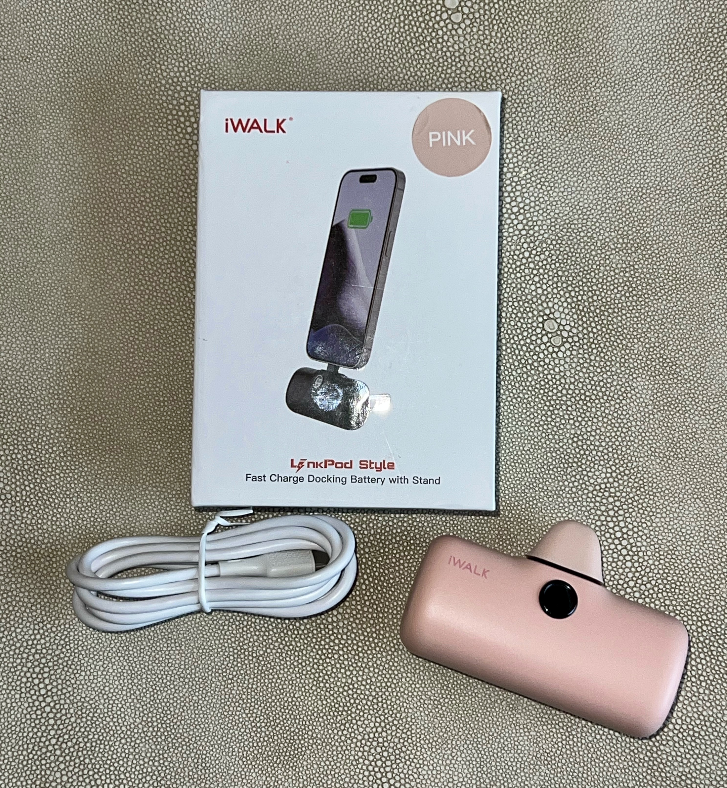 Close-up of the iWALK LinkPod Station's power button with a green indicator light.