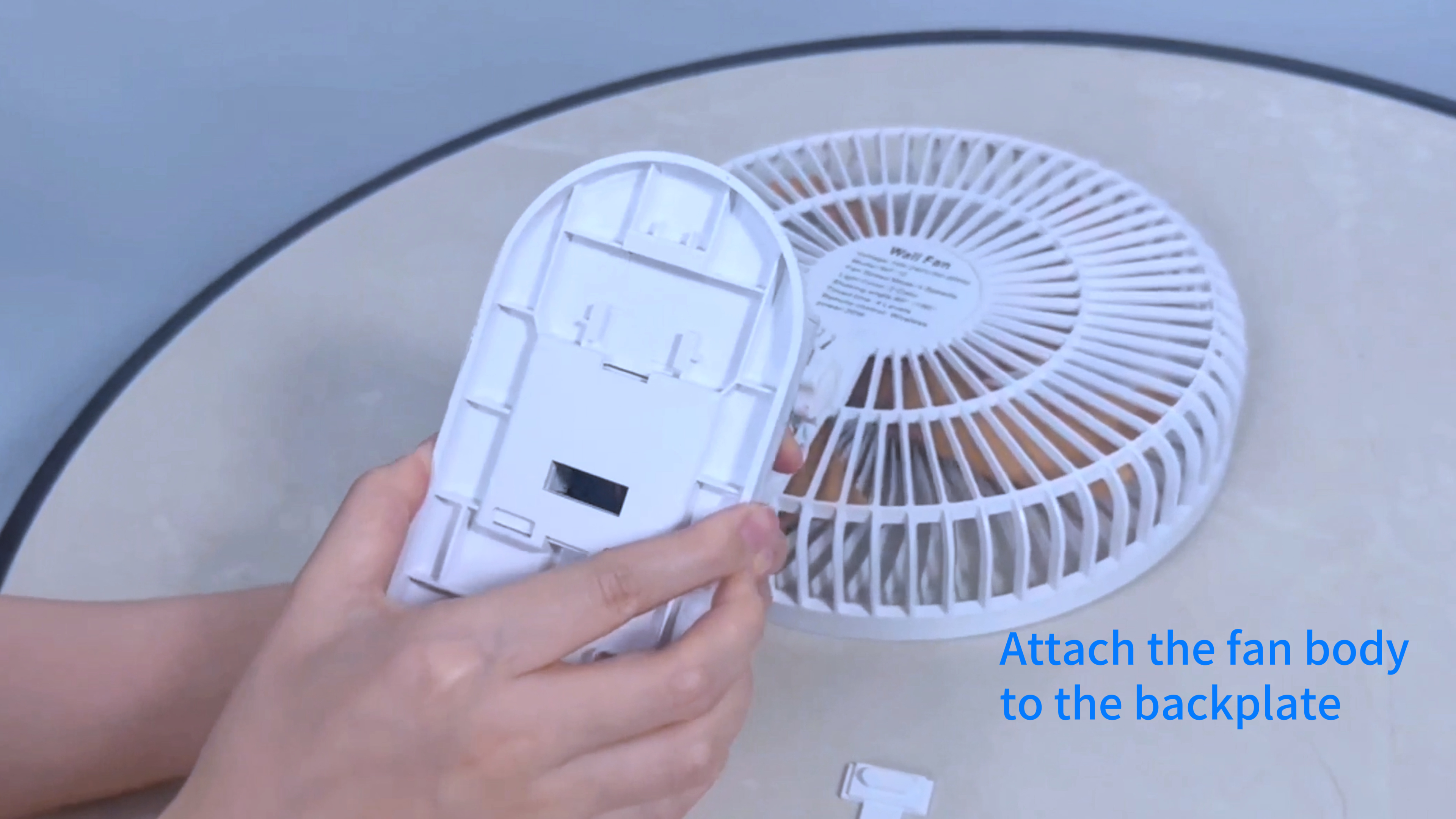 Close-up of hands attaching the Type-C plug to the fan's backplate during installation