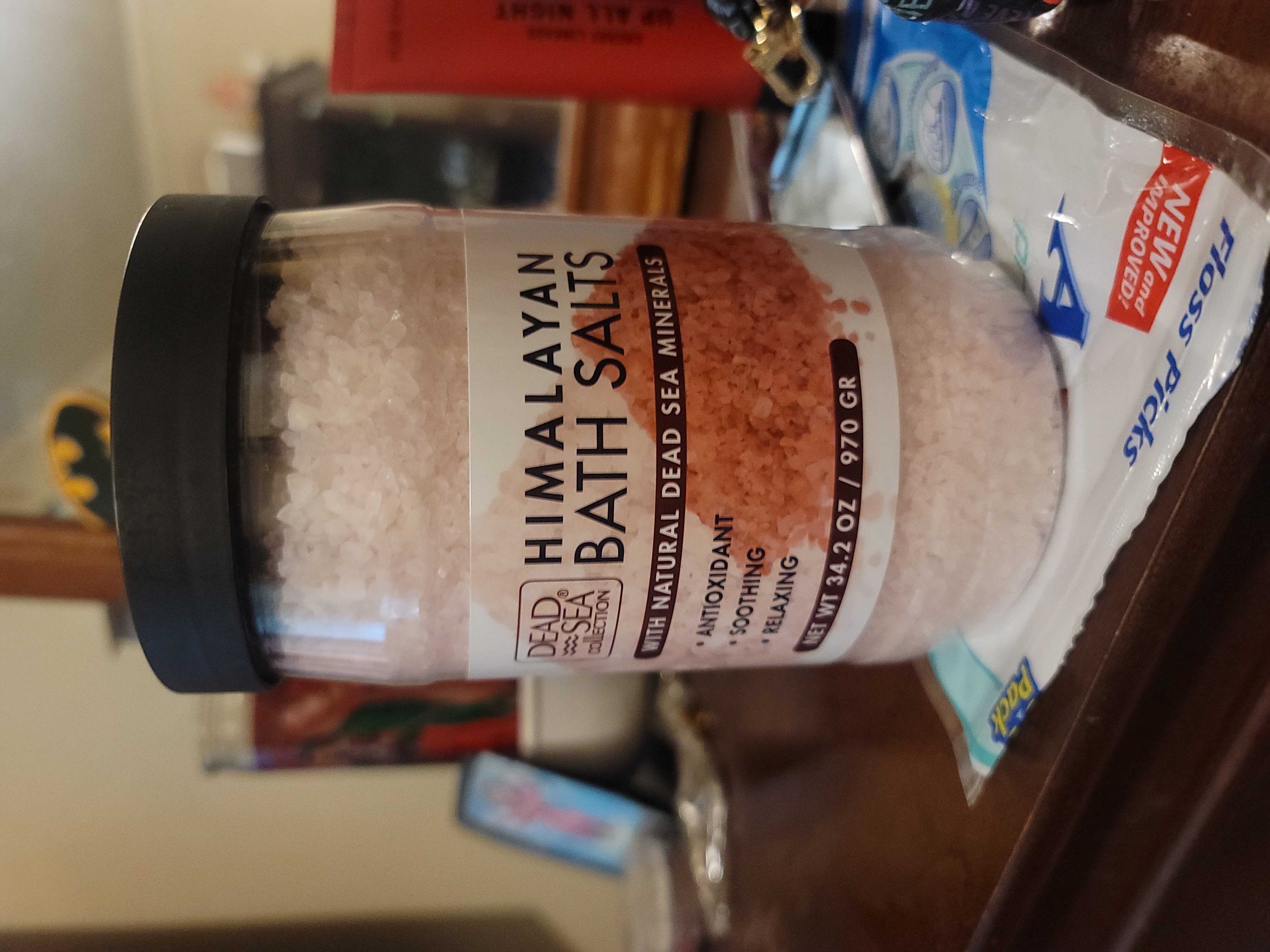 Himalayan pink bath salt in a wooden scoop with warm pink tones