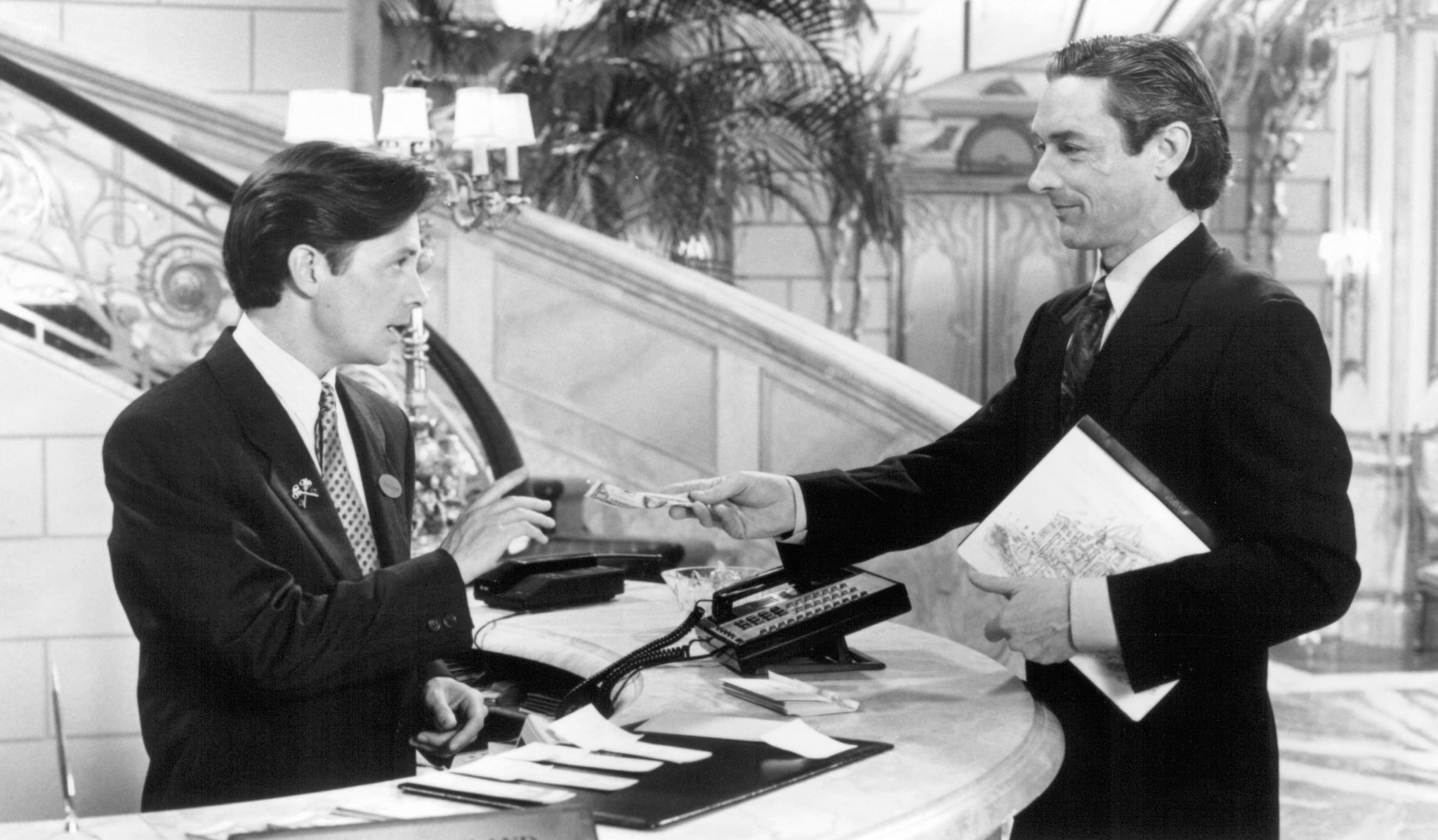 Michael J. Fox and Anthony Higgins in For Love or Money (1993)