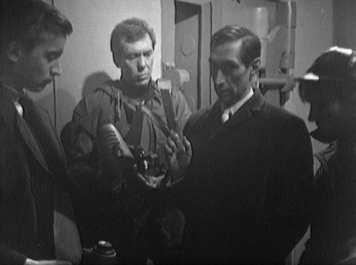 John D. Collins, Mike Pratt, Vladek Sheybal, and Virginia Wetherell in How to Rob a Bank - And Get Away with It (1966)