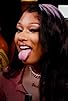 Primary photo for Megan Thee Stallion Turns Into Hot Girl Meg While Eating Spicy Wings Primary photo for Megan Thee Stallion Turns Into Hot Girl Meg While Eating Spicy Wings