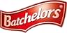 Red curved banner logo with white text reading 'Batchelors' in a stylized font. Logo has a glossy, three-dimensional appearance against a black background.