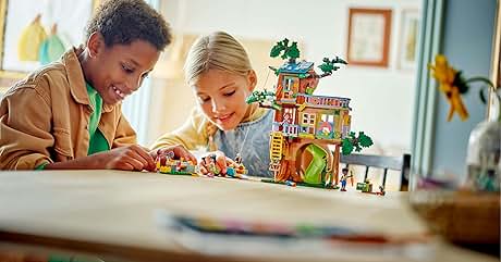 dos niños jugando con una casa de juguetes