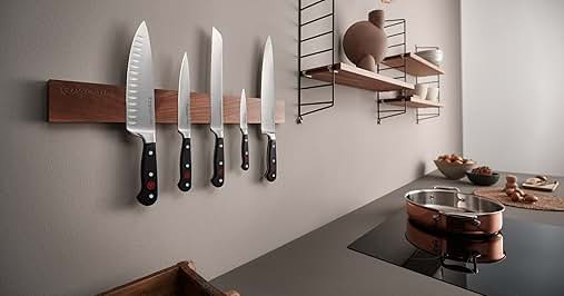 a set of knives hanging on a wall.