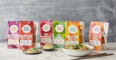 Collection of Spice Mama brand seasoning packets featuring Indonesian, Thai, and Malaysian curry flavors. Prepared dishes and chopsticks shown alongside.