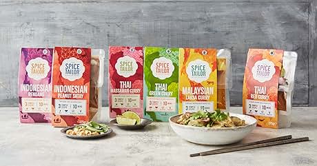 Collection of Spice Mama brand seasoning packets featuring Indonesian, Thai, and Malaysian curry flavors. Prepared dishes and chopsticks shown alongside.