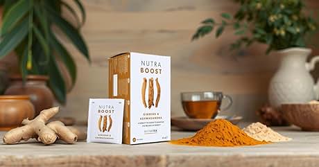 Product box labeled 'Nutra Boost' with image of ginger root, alongside fresh ginger, turmeric powder, and a lighter-colored powder on wooden surface. Kitchen items in background.