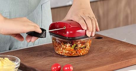 a person cutting up a vegetable salad