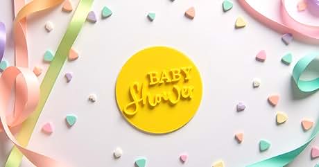 Text reads "BABY shower". Yellow circular tag with embossed text surrounded by pastel confetti hearts and curled ribbons on light background.