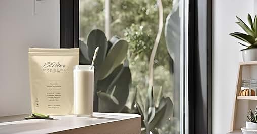 a glass of milk and a plant on a table