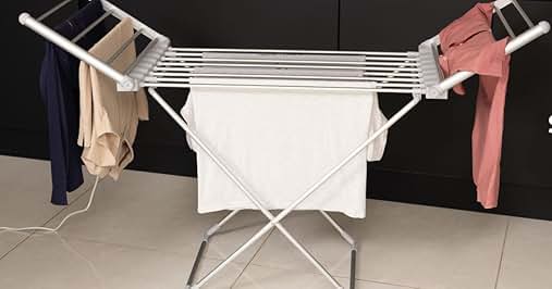 Expandable white clothes drying rack with multiple parallel lines for hanging, shown with clothing items attached.