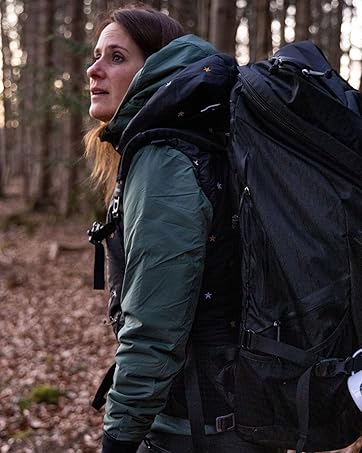 Photographer wearing backpack in woods