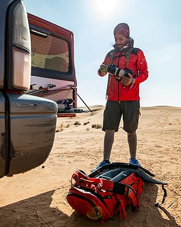 Photographer in desert adjusting camera