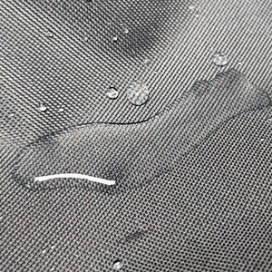 Close-up of water droplets beading on gray fabric surface, demonstrating water-resistant or waterproof textile properties.