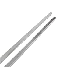 Zwei lange, dünne, silberfarbene Essstäbchen oder Utensilien aus Metall vor einem weißen Hintergrund.