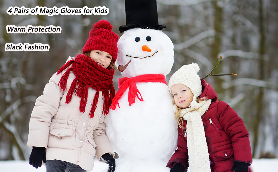 Two girls in black knit gloves build a snowman in winter snow.