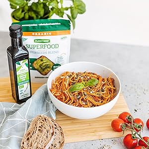 bread tomato hemp seeds basil and hemp seed oil on cutting table on the board boal of pasta