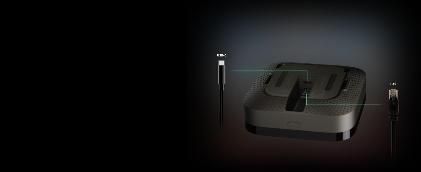 Black rectangular electronic device with smooth surface and rounded edges. Two ports visible on sides. Dark background with dramatic lighting.